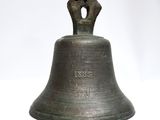 a close up of a bell on a white surface with a white background