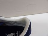 someone is wearing a pair of blue shoes with a white sole