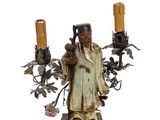 a figurine of a man holding two candles