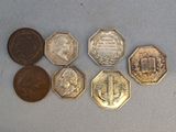 six different types of coins sitting on top of a white surface