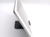 a white tablet computer sitting on top of a black stand