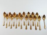 a lot of spoons that are lined up on the table