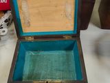 a small wooden box that is open on a table