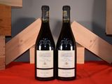 two bottles of wine sitting next to each other on a table