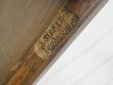 a close up of a wooden chair with a label on it