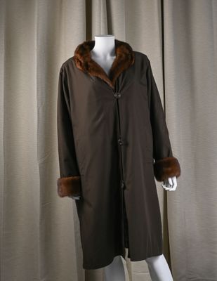 an image of a mannequin wearing a brown coat with a fur collar