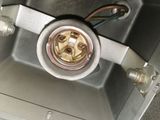 an overhead view of a metal box with a white electrical outlet