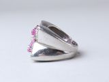 silver ring with pink stones on a white background