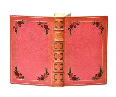 an old book with a rose design is open on a white background