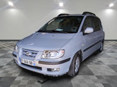 a picture of a small blue car parked in a garage