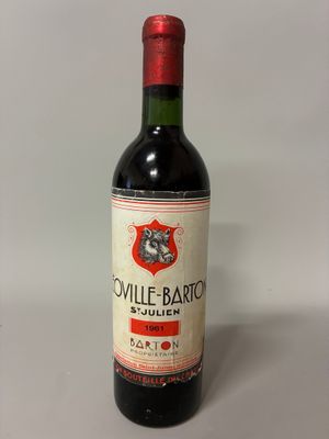an old bottle of wine sitting on top of a table