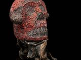 a close up of a sculpture of a skull on a black surface
