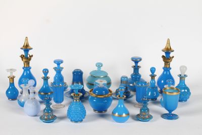 a lot of blue glass vases on a white surface