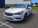 L'Opel blanche est garée sur un parking près d'un immeuble