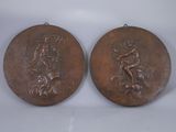 pair of bronze medallions depicting a man and a woman on a horse