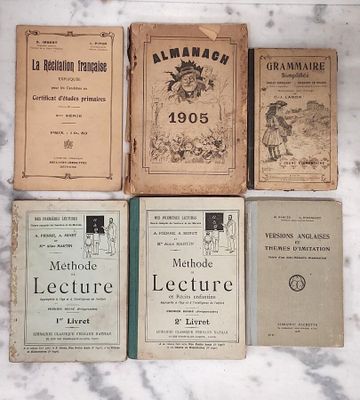 several old books sitting on top of a marble counter top