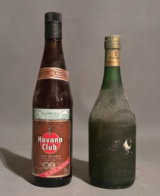 two bottles of alcohol sitting next to each other on a table