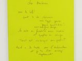 a yellow notebook with a handwritten note on it
