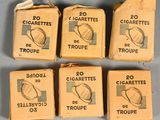six boxes of cigarettes sitting on top of a table next to each other