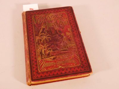 an old book sitting on top of a white table next to a card