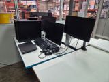 two computer monitors and a keyboard on a desk