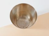 a metal bowl sitting on top of a table