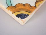 a picture of a ceramic plate with a bird on it