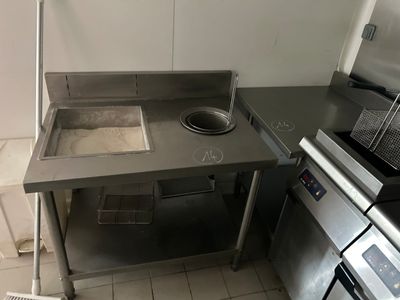 a kitchen with a stove, sink, and microwave in it