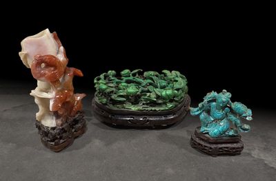trois figurines chinoises sculptées représentant des animaux et des plantes, posées sur une table