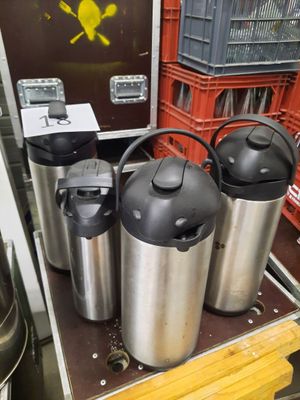 three kegs that are sitting on a shelf in a store