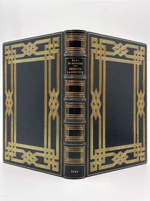 un vieux livre noir orné de dorures et d'une bordure dorée
