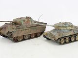 two toy tanks sitting next to each other on a white surface