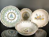 several different types of plates are sitting on a black surface