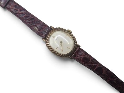 an image of a close up of a wrist watch on a white surface