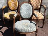 three chairs sitting next to each other on a sidewalk
