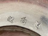 a close up of a metal object with chinese writing on it