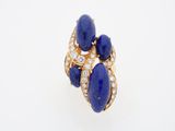 a close up of a gold ring with lapis and diamonds