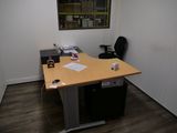 a desk with a chair and a computer on it