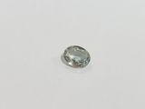 a close up of a green sapphire stone on a white surface