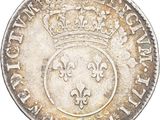 a close up of a coin with a crown on it