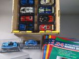 a box of assorted toy cars on a table