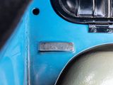 a close up of a blue car door with a metal latch