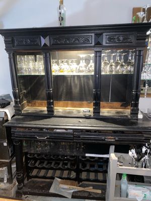 a black bar with a wine rack in the middle of it