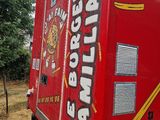 a red fire truck that is parked on the side of the road