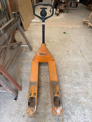 a fork lifter that is sitting in a garage