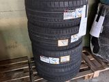 tires stacked up on pallets in a warehouse area