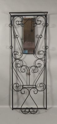 a mirror hanging on the wall next to a shelf