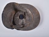a brown hat with a hole in it on a white surface