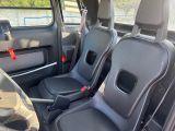 two seats in the back of a van that is empty