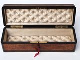 an open wooden box with a red ribbon hanging from it ' s side